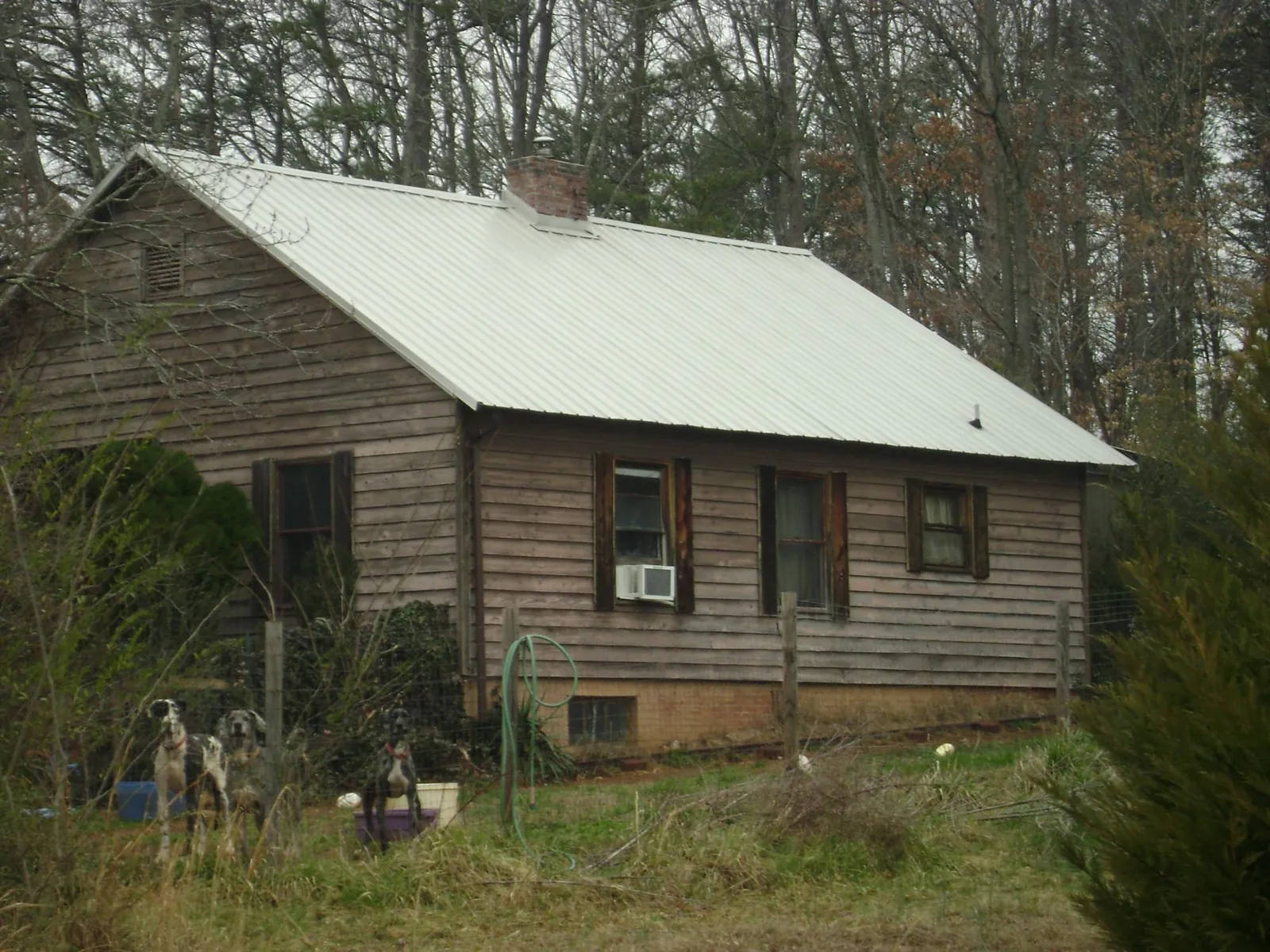 White metal roof on an old wood sided farmhouse, from a Metal Roof Installation job in Fair Lawn